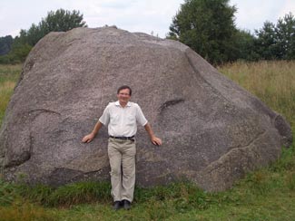 Dr. Rimantas Petrosius, University of Vilnius; geophysicist, in front of the "Devil's Stone" located in Northern vicinity of the &Scaron;vendubrė village. (c) Dr. Rimantas Petrosius, 2011